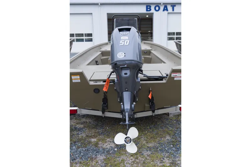 Slide: The Image of 2026 G3 Gator Tough 17 CC boat with 50 HP outboard motor, parked outside. - 9