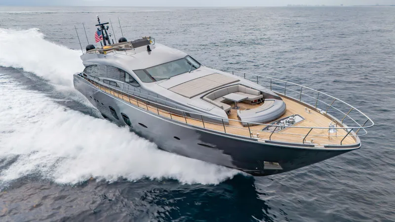 Slide: The Image of Luxury 2021 Pershing 108 yacht cruising on open sea, showcasing sleek design and spacious deck. - 27