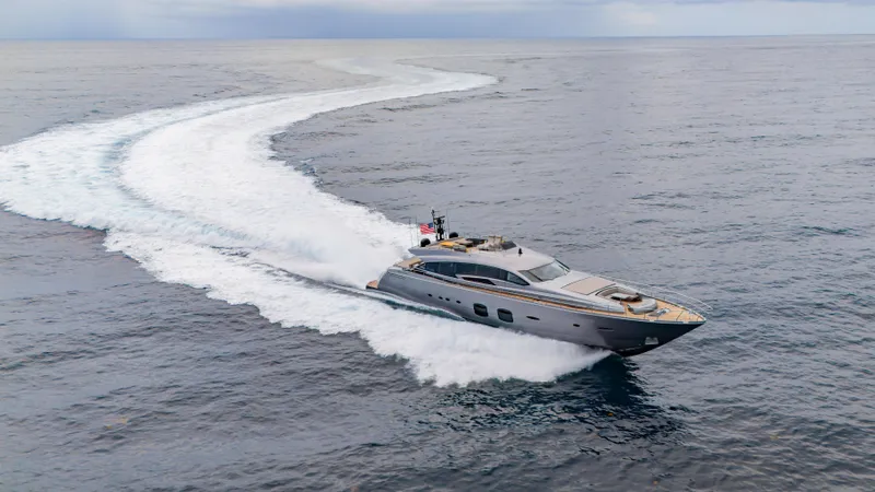 Slide: The Image of 2021 Pershing 108 yacht cruising swiftly on open sea, leaving a white wake trail. - 30