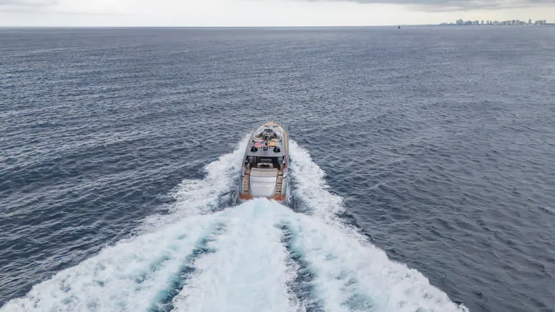 Slide: The Image of Aerial view of 2021 Pershing 108 yacht cruising on open sea. - 33