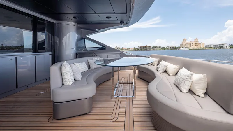 Slide: The Image of Luxurious 2021 Pershing 108 yacht deck with elegant seating and scenic waterfront view. - 35