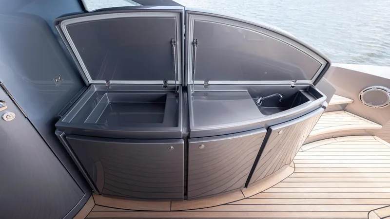 Slide: The Image of Outdoor kitchen area on 2021 Pershing 108 yacht with open storage compartments. - 36