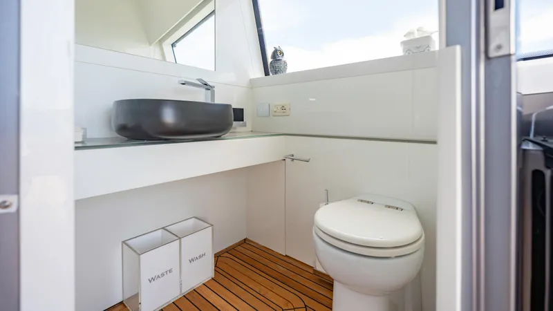 Slide: The Image of Modern bathroom on 2021 Pershing 108 yacht with sleek sink and wooden flooring. - 38