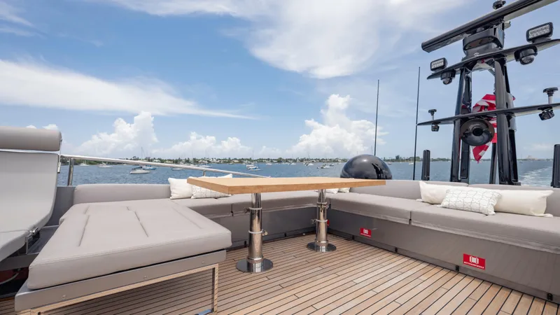 Slide: The Image of Luxurious 2021 Pershing 108 yacht deck with seating, table, and ocean view. - 43