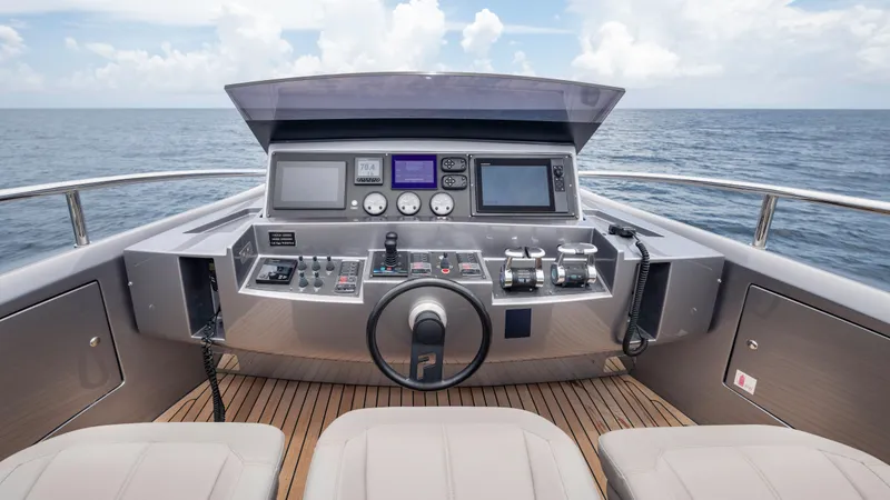 Slide: The Image of Cockpit of 2021 Pershing 108 yacht with modern navigation controls and ocean view. - 45