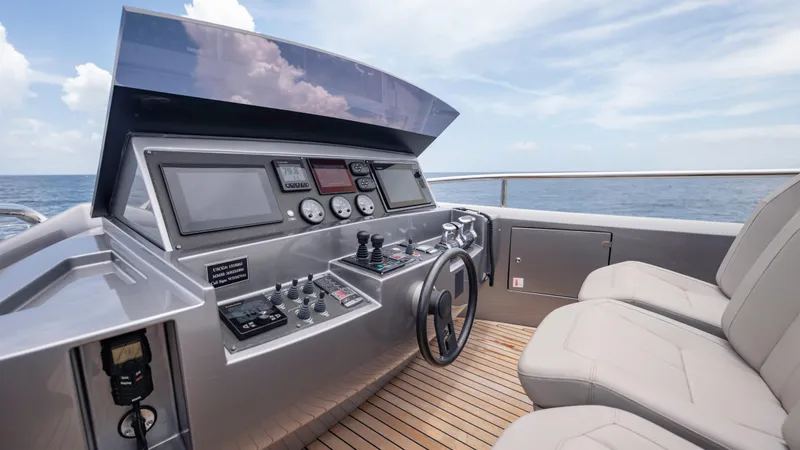Slide: The Image of Helm of 2021 Pershing 108 yacht with modern controls and ocean view. - 46