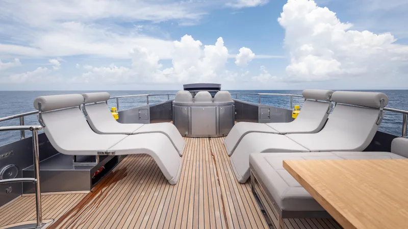 Slide: The Image of Luxurious deck of 2021 Pershing 108 yacht with modern lounge chairs and ocean view. - 48