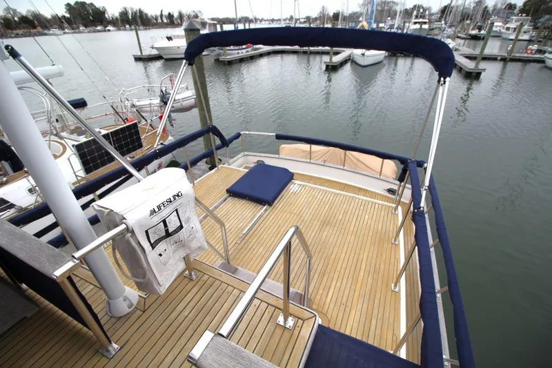 Slide: The Image of 1986 DeFever 41 Trawler deck with railing, docked at marina. - 11