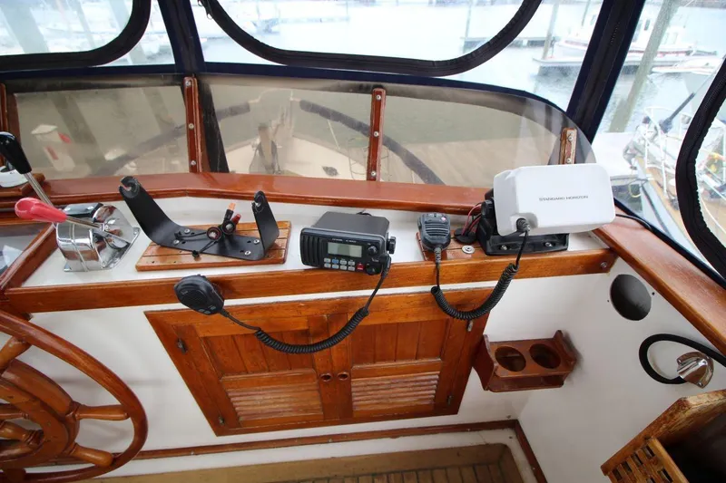 Slide: The Image of 1986 DeFever 41 Trawler helm with navigation equipment and wooden steering wheel. - 16