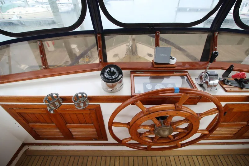 Slide: The Image of 1986 DeFever 41 Trawler helm with wooden wheel and navigation instruments. - 17