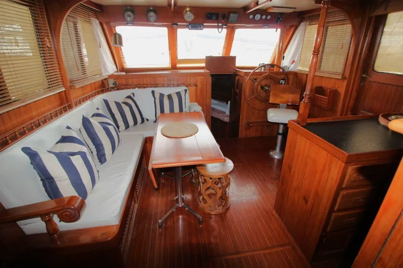 Slide: The Image of Interior of 1986 DeFever 41 Trawler with wooden decor and striped cushions. - 18