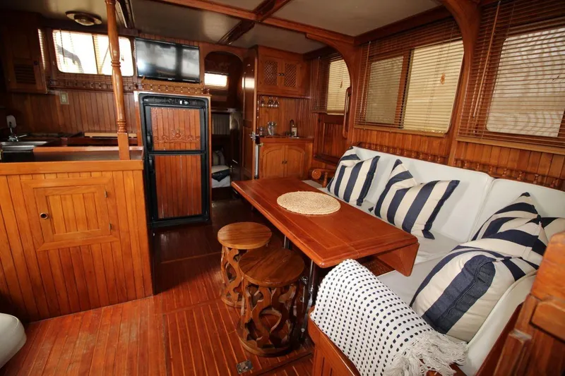 Slide: The Image of Interior of 1986 DeFever 41 Trawler with wooden decor and cozy seating area. - 19
