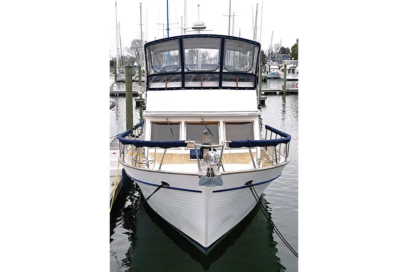 Slide: The Image of 1986 DeFever 41 Trawler docked at marina, front view. - 2