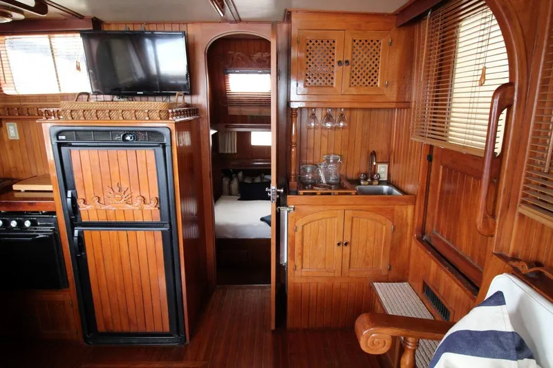 Slide: The Image of Interior of 1986 DeFever 41 Trawler with wooden cabinetry and modern amenities. - 21