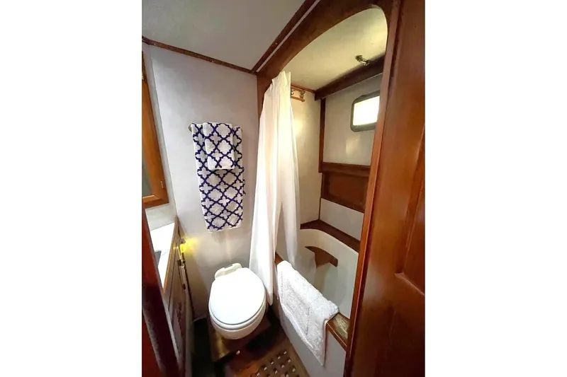 Slide: The Image of Bathroom interior of 1986 DeFever 41 Trawler with wooden accents and nautical decor. - 26