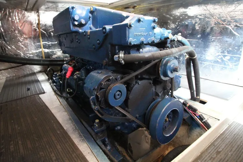 Slide: The Image of Engine room of a 1986 DeFever 41 Trawler, showcasing a blue marine engine. - 31