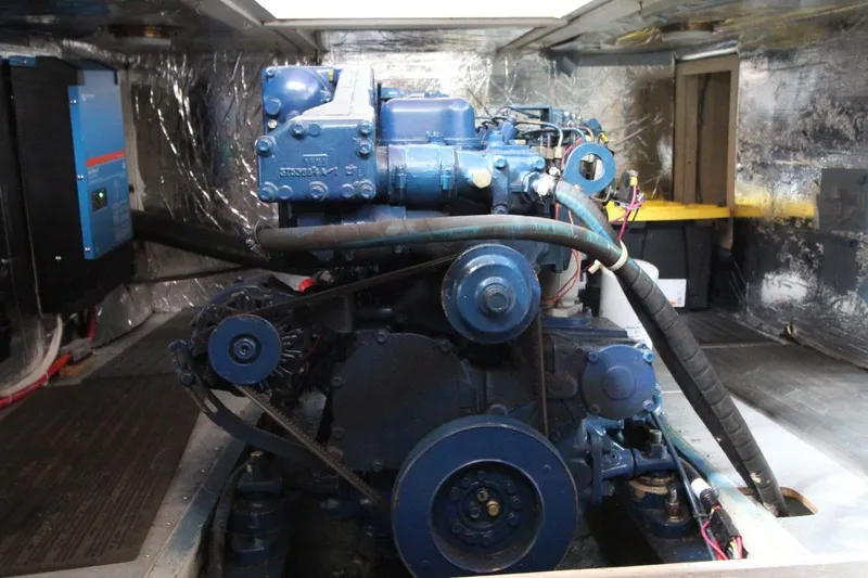 Slide: The Image of Engine room of a 1986 DeFever 41 Trawler, showcasing a blue marine engine. - 33