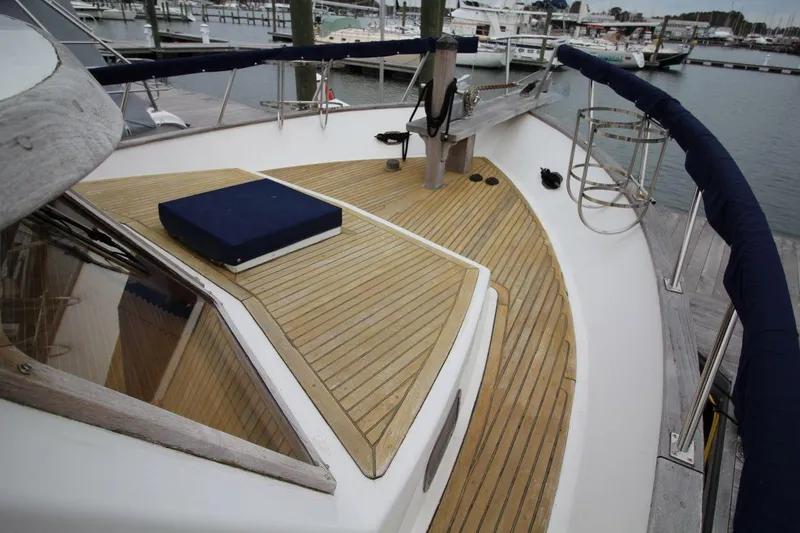 Slide: The Image of 1986 DeFever 41 Trawler deck with wooden finish and marina view. - 8