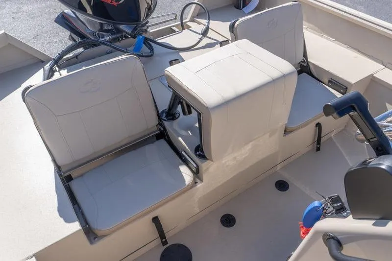 Slide: The Image of 2026 G3 Bay 20 boat interior with beige seating and steering console. - 15