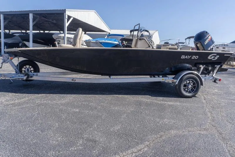 Slide: The Image of 2026 G3 Bay 20 boat on trailer, parked outdoors under clear sky. - 2