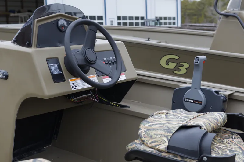 Slide: The Image of 2026 G3 Gator Tough 17 SC boat interior with steering wheel and Yamaha controls. - 8