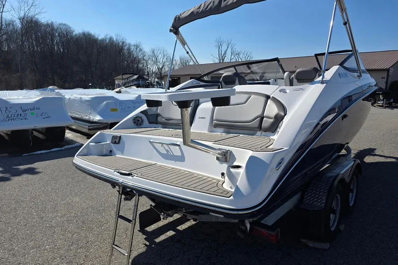 Slide: The Image of 2017 Yamaha Boats 212 Limited on trailer, rear view, outdoor setting. - 10