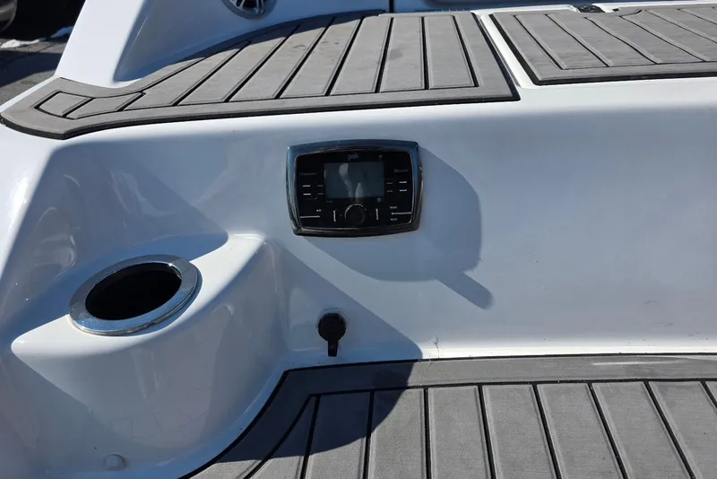 Slide: The Image of 2017 Yamaha Boats 212 Limited deck with control panel and cup holder. - 11