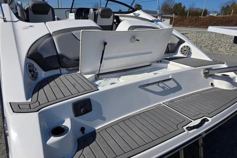 Slide: The Image of 2017 Yamaha Boats 212 Limited interior with open storage compartment and seating. - 12