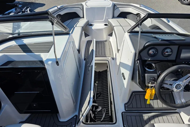 Slide: The Image of 2017 Yamaha Boats 212 Limited interior with seating, steering wheel, and storage compartment. - 16