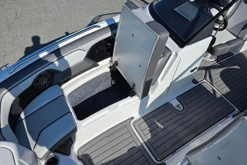 Slide: The Image of 2017 Yamaha Boats 212 Limited interior with open storage compartment and seating. - 19