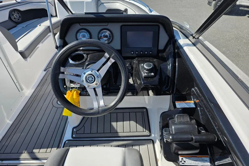 Slide: The Image of 2017 Yamaha Boats 212 Limited dashboard with steering wheel and control panel. - 26