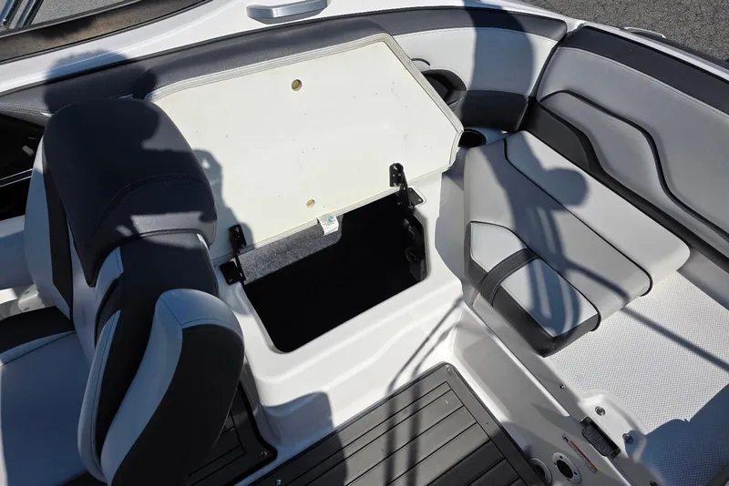 Slide: The Image of 2017 Yamaha Boats 212 Limited interior storage compartment with open hatch. - 29
