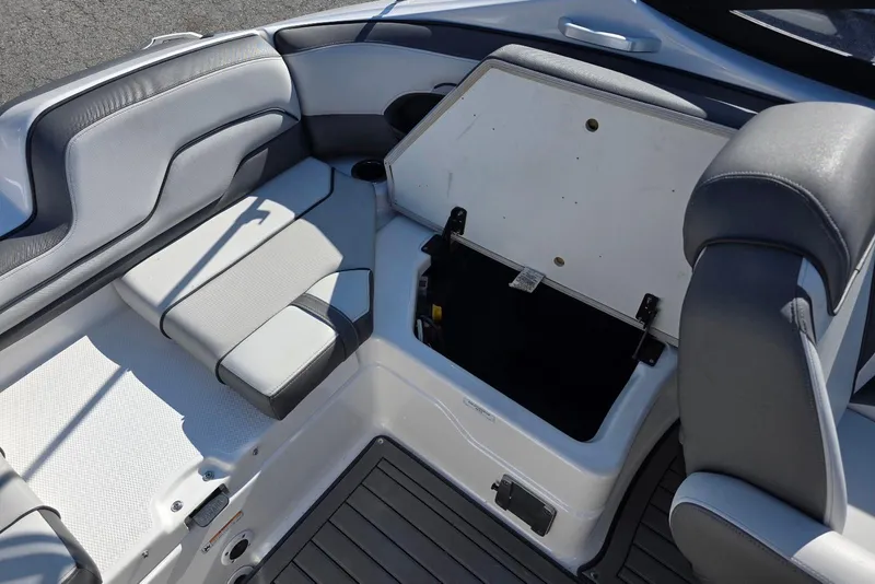 Slide: The Image of 2017 Yamaha Boats 212 Limited interior seating with open storage compartment. - 30