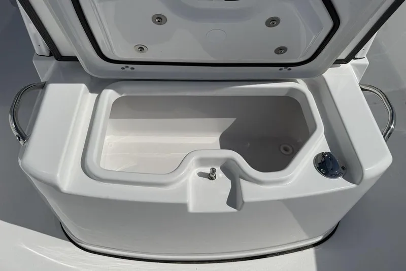Slide: The Image of 2026 Sportsman Open 252 Center Console boat storage compartment, open lid view. - 11