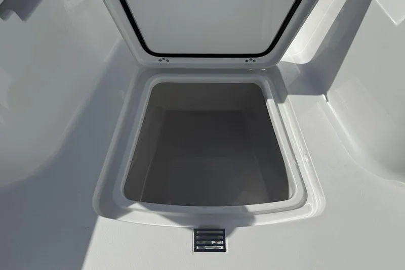 Slide: The Image of 2026 Sportsman Open 252 Center Console storage compartment, open and empty. - 12