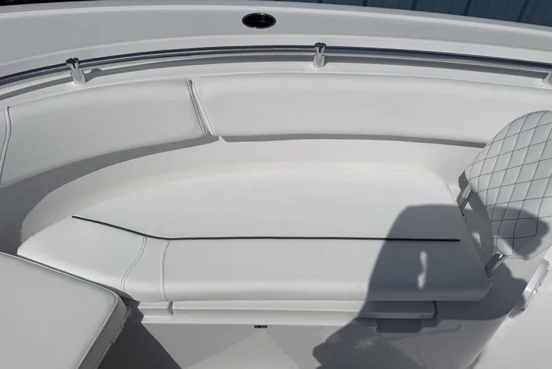 Slide: The Image of 2026 Sportsman Open 252 Center Console boat interior with white cushioned seating. - 13