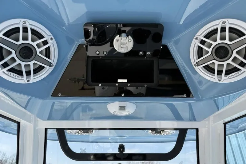 Slide: The Image of 2026 Sportsman Open 252 Center Console with JL Audio speakers and blue interior. - 19