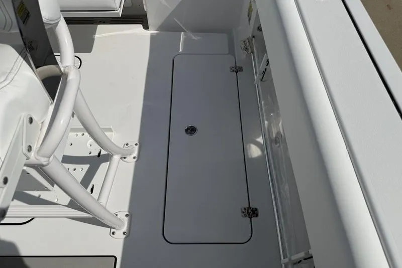 Slide: The Image of 2026 Sportsman Open 252 Center Console boat interior with storage compartment. - 26