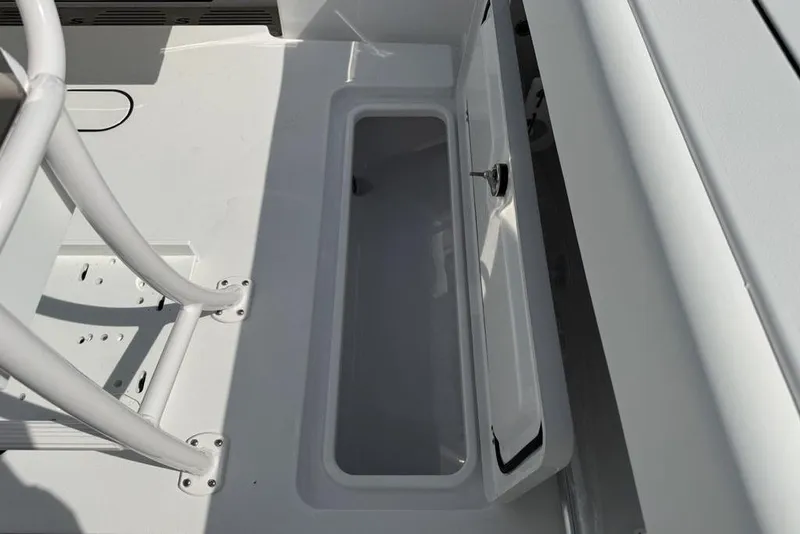 Slide: The Image of 2026 Sportsman Open 252 Center Console storage compartment with open hatch. - 28