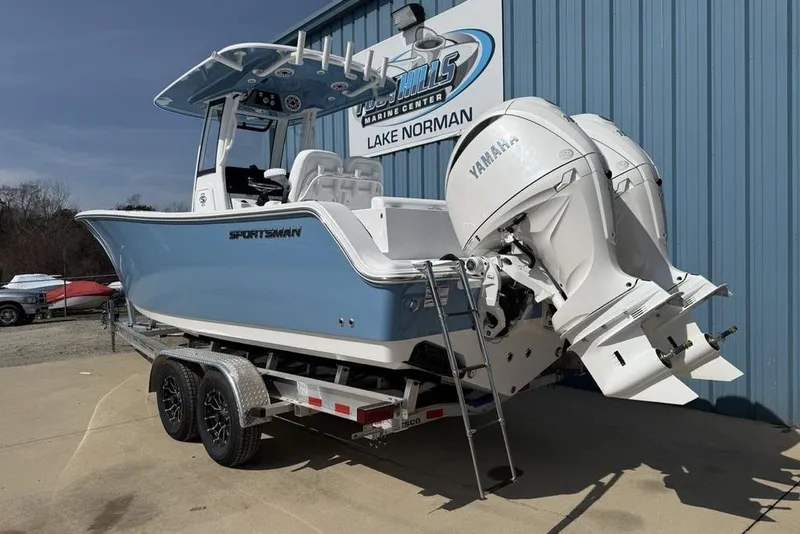 Slide: The Image of 2026 Sportsman Open 252 Center Console boat with dual Yamaha engines on a trailer. - 3
