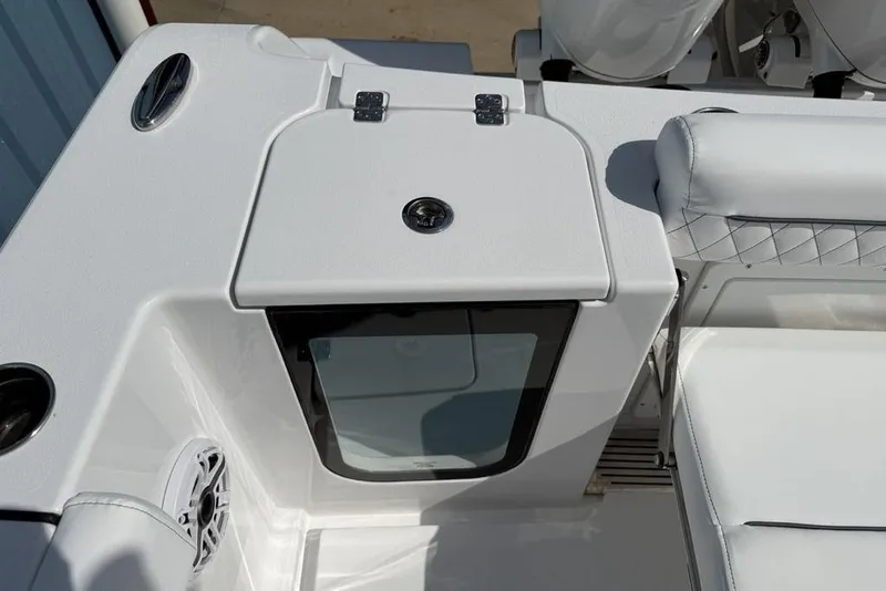 Slide: The Image of 2026 Sportsman Open 252 Center Console boat interior with seating and storage compartment. - 33