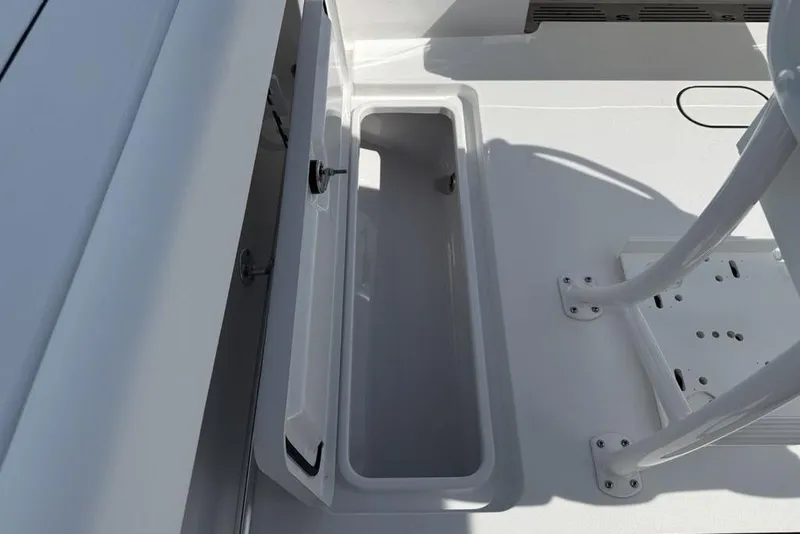 Slide: The Image of 2026 Sportsman Open 252 Center Console boat storage compartment, open and empty. - 37