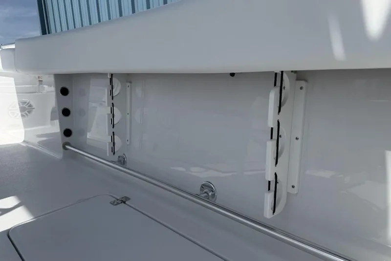 Slide: The Image of 2026 Sportsman Open 252 Center Console boat interior, featuring rod holders and storage compartments. - 40