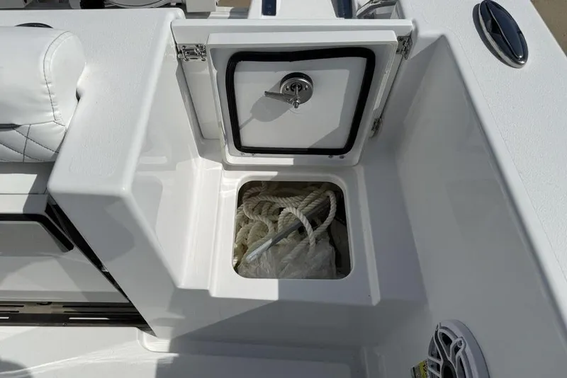 Slide: The Image of 2026 Sportsman Open 252 Center Console boat storage compartment with rope inside. - 42