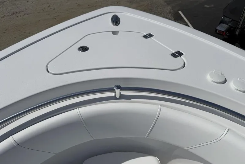 Slide: The Image of 2026 Sportsman Open 252 Center Console boat, featuring sleek white seating and storage compartment. - 8