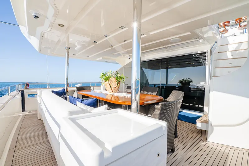 Slide: The Image of Luxurious yacht deck with elegant seating, dining table, and ocean view, Custom Line 100, 2012 model. - 10