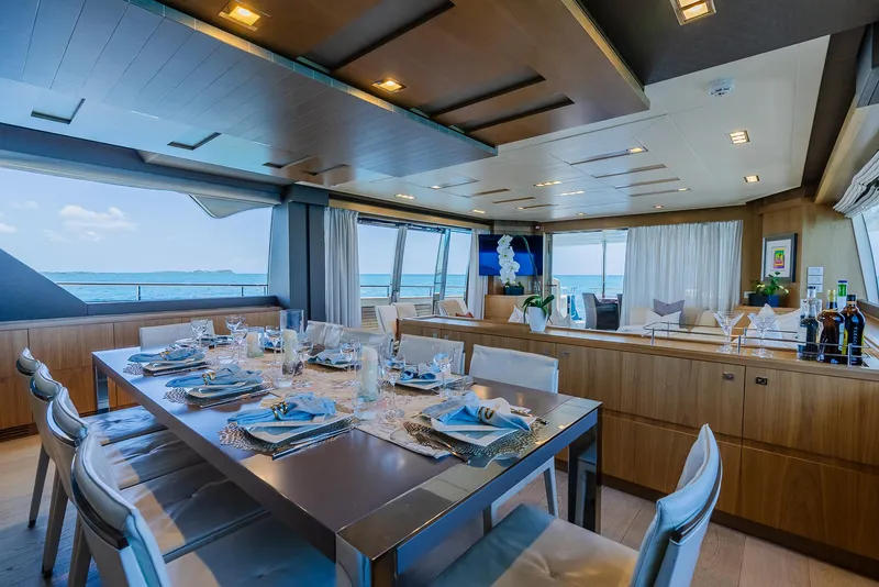 Slide: The Image of Luxurious yacht interior with elegant dining setup, panoramic windows, and modern decor, Custom Line 100, 2012. - 15