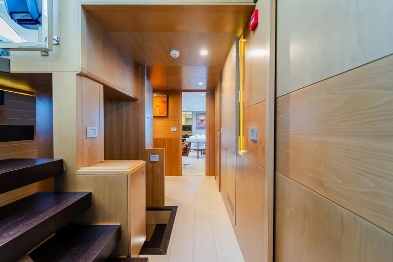 Slide: The Image of Luxurious yacht interior with wooden paneling, modern staircase, and ambient lighting, Custom Line 100, 2012. - 16