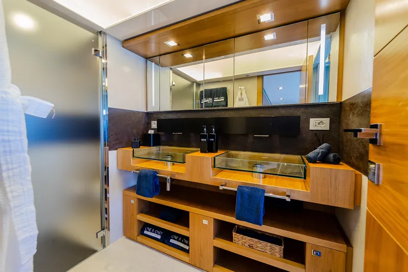 Slide: The Image of Luxurious yacht bathroom with dual glass sinks, wooden cabinetry, and modern fixtures, Custom Line 100, 2012. - 20