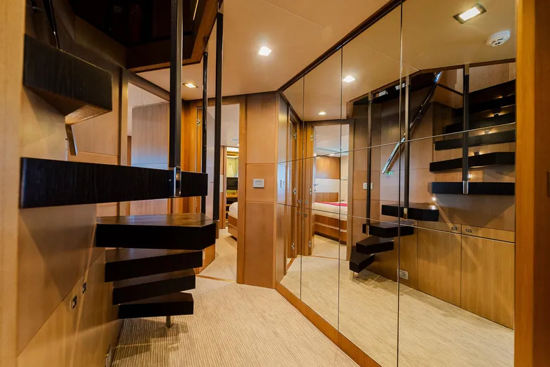 Slide: The Image of Luxurious yacht interior with mirrored walls, modern staircase, and elegant wood finishes, Custom Line 100, 2012. - 22